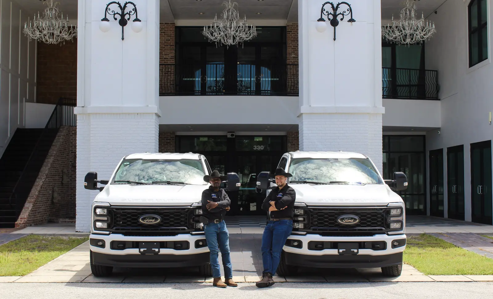 Michael Austin and Joshua Alvarez-Brown with Bethel Built Construction field trucks