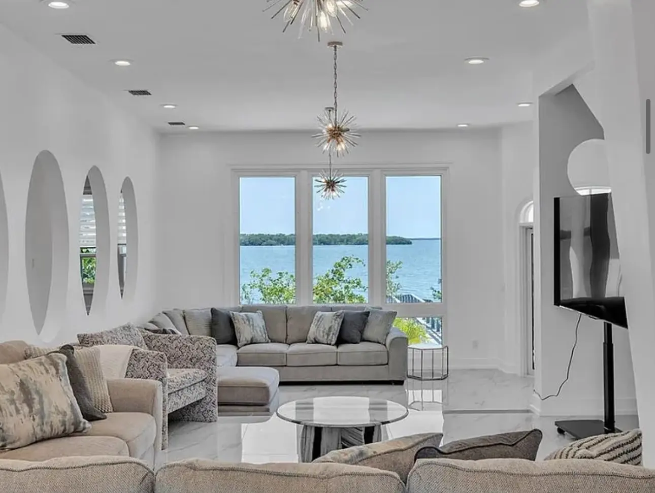 Renovated waterfront living room with bright finishes and open views
