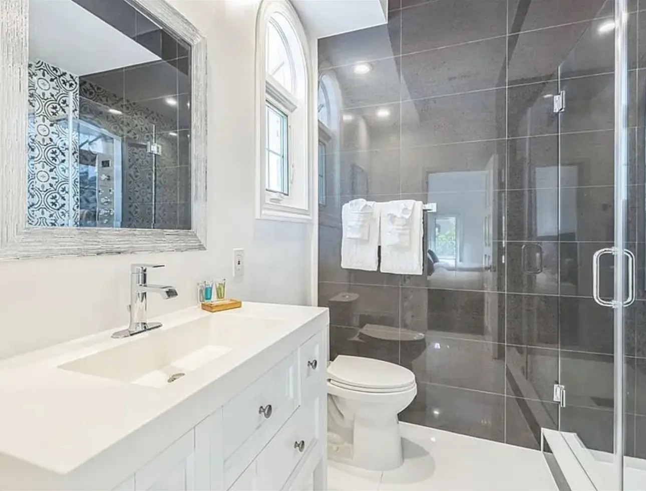 Completed Tampa bathroom with glass shower, vanity, and bright tile finishes