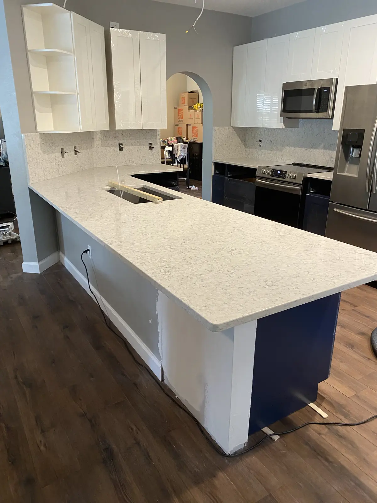 Kitchen rehabilitation with new cabinetry, counters, and flooring